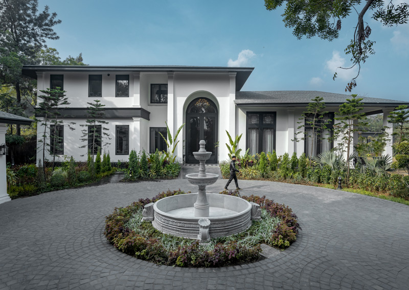 The towering 20-foot-tall door, crafted with exquisite wood, stretches proudly across 10 feet, making a bold statement in luxury and craftsmanship.